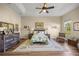 Charming bedroom featuring a ceiling fan, a large window, and cozy decor at 3948 Se 4Th Ter, Ocala, FL 34480