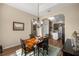 Dining room with wood floors, classic chandelier, and open archway at 3948 Se 4Th Ter, Ocala, FL 34480
