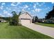 Well-maintained home featuring a manicured lawn and a long driveway leading to the garage at 3948 Se 4Th Ter, Ocala, FL 34480