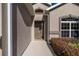 Close up of front door with sidelight window and manicured landscaping at 3948 Se 4Th Ter, Ocala, FL 34480