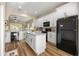 Bright kitchen featuring white cabinets, stainless steel appliances, granite countertops and center island at 3948 Se 4Th Ter, Ocala, FL 34480