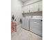 Functional laundry room with washer, dryer, and ample cabinet space at 3948 Se 4Th Ter, Ocala, FL 34480