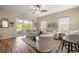 Living room with wood floors and sliding glass doors leading to the patio at 3948 Se 4Th Ter, Ocala, FL 34480