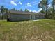 Well-maintained backyard featuring a sliding glass door leading to the patio and a grassy lawn at 5185 Sw 158Th Pl, Ocala, FL 34473
