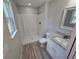 Bathroom features a granite vanity, a white cabinet, a shower, and a window at 5185 Sw 158Th Pl, Ocala, FL 34473