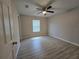 Bedroom featuring wood-look floors, a ceiling fan, neutral paint, and a window at 5185 Sw 158Th Pl, Ocala, FL 34473