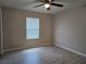 Bedroom featuring wood-look floors, a ceiling fan, neutral paint, and a window at 5185 Sw 158Th Pl, Ocala, FL 34473