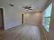 Inviting bedroom with ceiling fan and window providing views and fills the room with natural light at 5185 Sw 158Th Pl, Ocala, FL 34473
