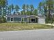 Charming home featuring a manicured lawn, attached one-car garage, and tasteful landscaping at 5185 Sw 158Th Pl, Ocala, FL 34473