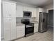 Contemporary kitchen with stainless steel appliances, granite countertops, and sleek, white cabinetry at 5185 Sw 158Th Pl, Ocala, FL 34473