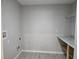 Spacious laundry room with gray wood-look flooring, granite countertop and metal shelving for ample storage at 5185 Sw 158Th Pl, Ocala, FL 34473