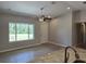 Open concept living room with a ceiling fan, and a view of the front yard through a large window at 5185 Sw 158Th Pl, Ocala, FL 34473