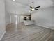 Open-concept living room and kitchen featuring modern flooring and plenty of natural light at 5185 Sw 158Th Pl, Ocala, FL 34473