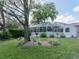 Enjoy this meticulously maintained yard featuring an enclosed lanai and beautiful trees and shrubbery at 5347 Pecan Rd, Ocala, FL 34472
