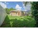 The spacious backyard features a well-maintained lawn and a screened-in lanai for outdoor enjoyment at 5347 Pecan Rd, Ocala, FL 34472