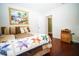 Cozy bedroom featuring hardwood floors, a queen size bed, and bright decor at 5347 Pecan Rd, Ocala, FL 34472