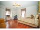 Comfortable bedroom with wood floors, windows with curtains, and a ceiling fan at 5347 Pecan Rd, Ocala, FL 34472