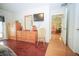 Spacious bedroom featuring wood floors, natural lighting, dresser, and wall-mounted television at 5347 Pecan Rd, Ocala, FL 34472