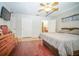 Cozy bedroom with ceiling fan, wood floors, a dresser, and ensuite bathroom at 5347 Pecan Rd, Ocala, FL 34472