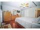 Bright bedroom showcasing wood floors, ceiling fan, furniture, and ensuite bathroom at 5347 Pecan Rd, Ocala, FL 34472