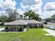 Charming single-story home with a well-manicured lawn and lovely landscaping at 5347 Pecan Rd, Ocala, FL 34472