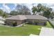 Charming single-story home with a well-manicured lawn and lovely landscaping at 5347 Pecan Rd, Ocala, FL 34472