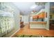 Open kitchen with wood cabinets, stainless steel appliances, and a charming breakfast nook at 5347 Pecan Rd, Ocala, FL 34472