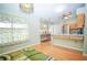 Bright kitchen with wooden cabinets, stainless appliances and view to breakfast nook at 5347 Pecan Rd, Ocala, FL 34472