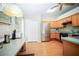 Efficient kitchen layout featuring stainless steel appliances, wooden cabinets, and laminate flooring at 5347 Pecan Rd, Ocala, FL 34472