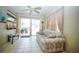 Bright living room with tiled floors, ceiling fan, neutral colors, and sliding glass doors leading to the outdoors at 5347 Pecan Rd, Ocala, FL 34472
