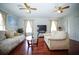 Inviting living room with wood floors, two sofas, two ceiling fans, and natural light at 5347 Pecan Rd, Ocala, FL 34472