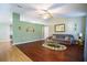 A living room with a ceiling fan and hardwood floors at 5347 Pecan Rd, Ocala, FL 34472