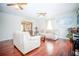 Comfortable living room with sofas, wood floors, ceiling fans, and an open layout at 5347 Pecan Rd, Ocala, FL 34472