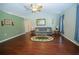 Inviting living room with hardwood floors, light green walls, and a ceiling fan at 5347 Pecan Rd, Ocala, FL 34472