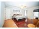 Spacious main bedroom with hardwood floors, large windows, and private ensuite at 5347 Pecan Rd, Ocala, FL 34472