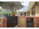Built-in outdoor kitchen featuring brick accents, covered grill area, and ample counter space for outdoor cooking at 5347 Pecan Rd, Ocala, FL 34472