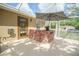 A covered outdoor kitchen area perfect for grilling and entertaining next to the screened in pool at 5347 Pecan Rd, Ocala, FL 34472