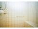 Well-lit walk-in shower with tiled walls and seating bench at 5347 Pecan Rd, Ocala, FL 34472