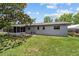 View of the backyard showcasing a screened in porch, large yard, and white tent structure at 5500 Se 2Nd Pl, Ocala, FL 34480