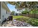 Fenced backyard featuring a storage shed and a concrete paver patio under the shade of a mature tree at 5500 Se 2Nd Pl, Ocala, FL 34480