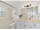 Well-lit bathroom featuring vanity, tub with shower and updated fixtures at 5500 Se 2Nd Pl, Ocala, FL 34480