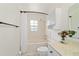 Bright bathroom featuring a tub with shower, marble countertop, and white cabinets at 5500 Se 2Nd Pl, Ocala, FL 34480