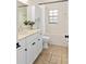 Bathroom with tub/shower combo, light countertops, and white cabinets at 5500 Se 2Nd Pl, Ocala, FL 34480