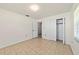 Bedroom with tiled floor, closet, and bright windows at 5500 Se 2Nd Pl, Ocala, FL 34480