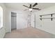 Spacious bedroom with carpet, ceiling fan, closet, and mounted shelves at 5500 Se 2Nd Pl, Ocala, FL 34480