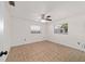 Simple, bright bedroom with neutral tones, tiled flooring, a ceiling fan and two windows at 5500 Se 2Nd Pl, Ocala, FL 34480
