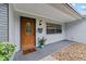 Close up of front door adorned with charming accents, alongside decorative plants, creating a welcoming entrance at 5500 Se 2Nd Pl, Ocala, FL 34480