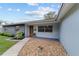 Inviting front porch with a charming wood door, decorative accents, and colorful plants enhance curb appeal at 5500 Se 2Nd Pl, Ocala, FL 34480