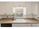 Modern kitchen features bright lighting, white cabinets, and granite countertops at 5500 Se 2Nd Pl, Ocala, FL 34480