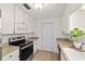 Bright kitchen features a modern oven, microwave, white cabinetry, and ample counter space at 5500 Se 2Nd Pl, Ocala, FL 34480